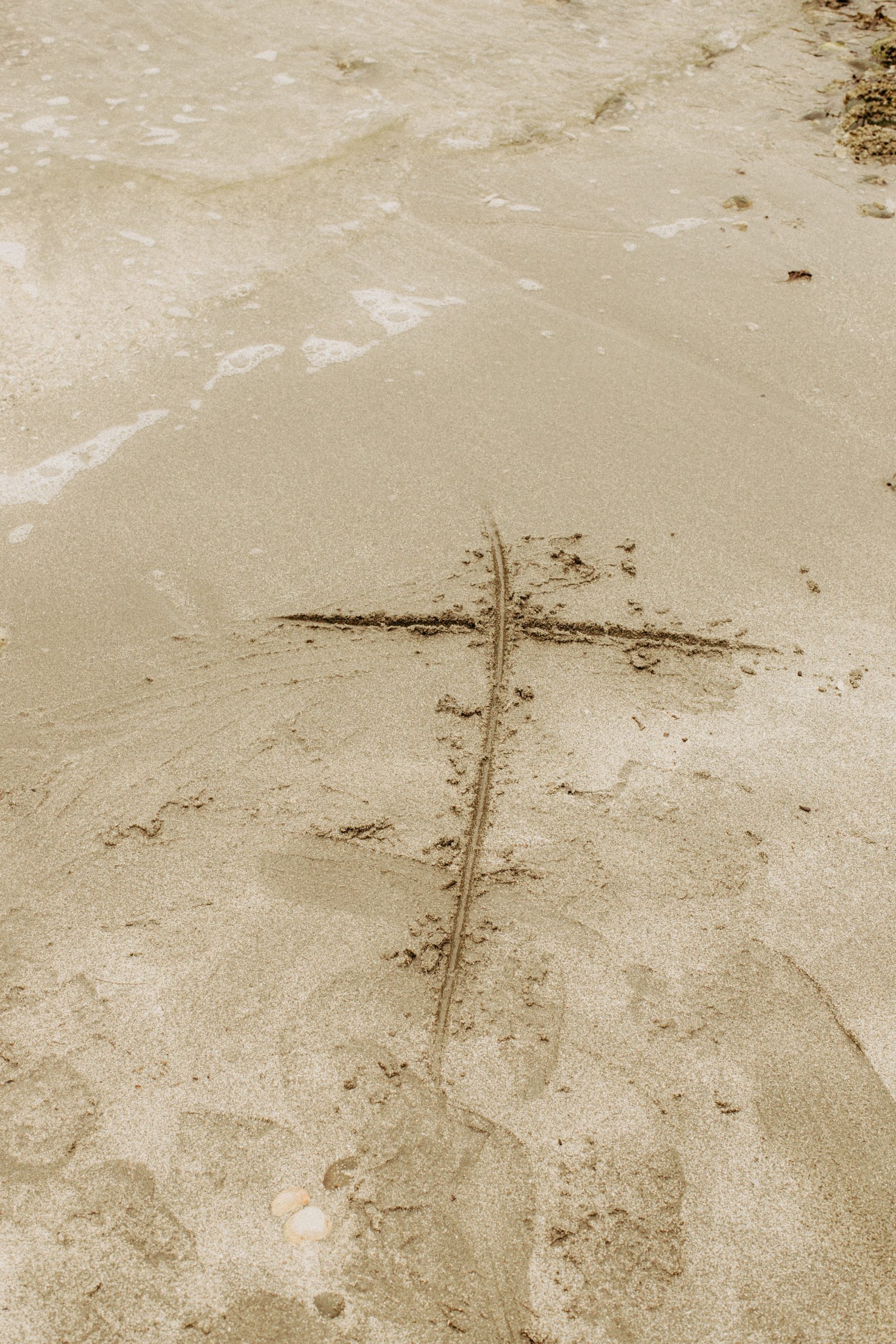 Cross on sandy beach