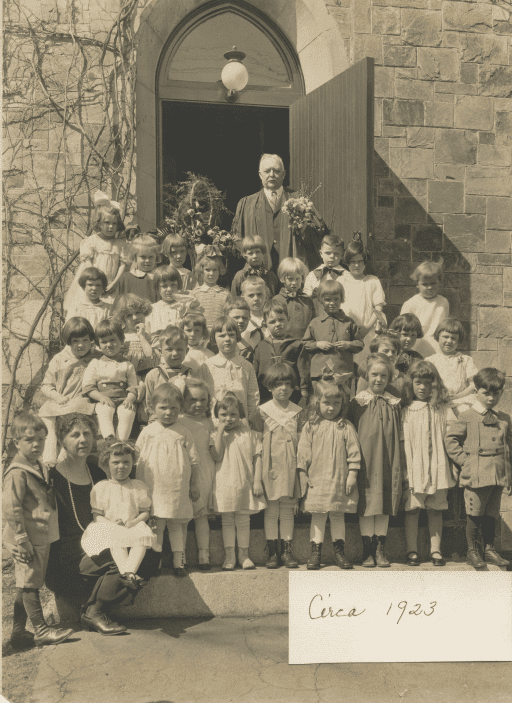 The children assemble on the steps of the church circa 1923