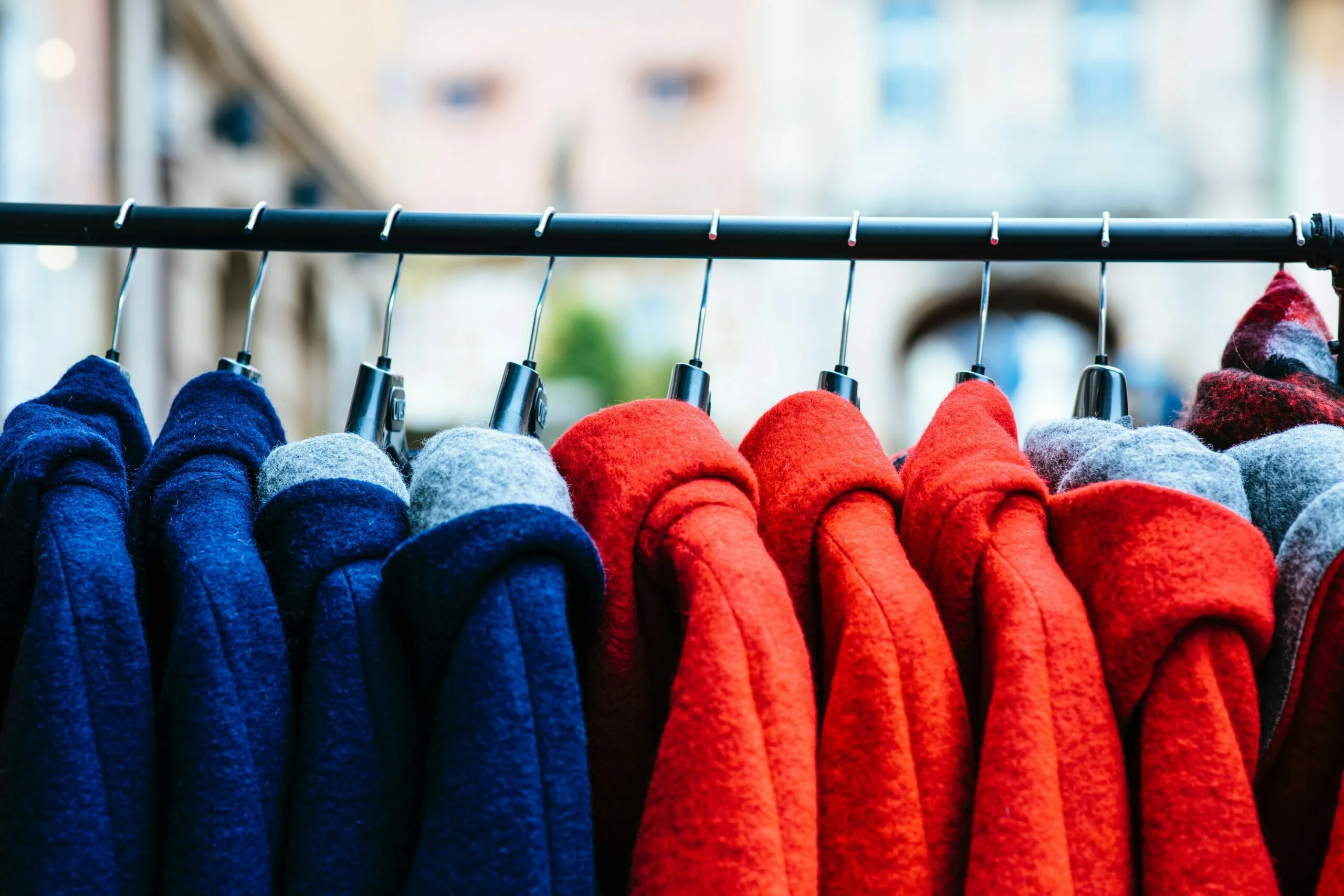 coats hanging on a bar