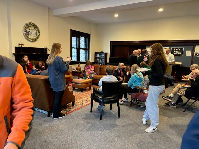People eating pizza in church parlor after Family Promise Metrowest Walk to End Homelessness