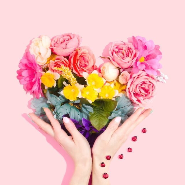 heart-shaped flower wreath in hands