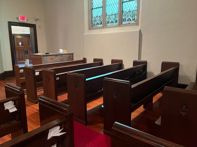 Empty pews with no organ pipes