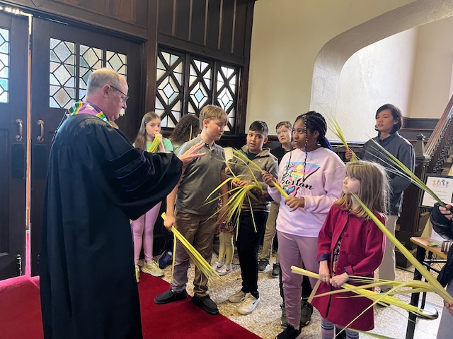 Children with palms on Palm Sunday and Ken Baily