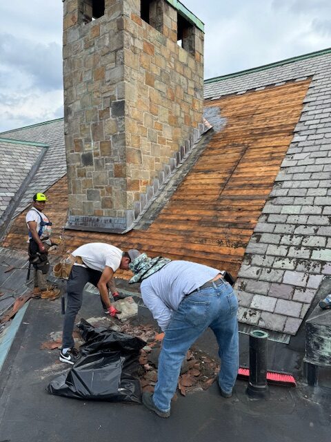 Workers fixing church roof