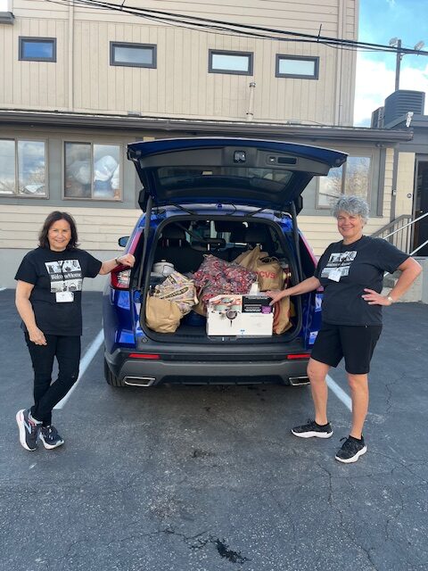 2 volunteers with carload of donated cookware