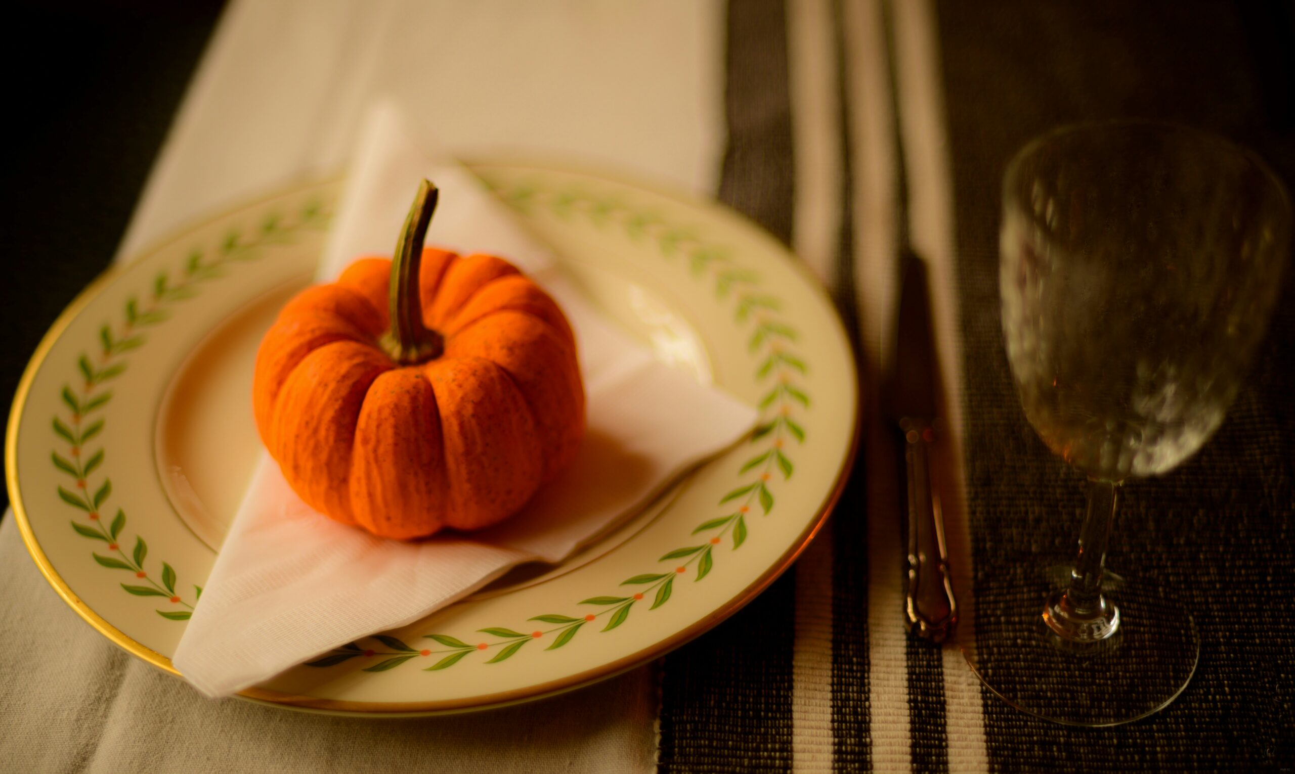 small orange gourd on dinner plate