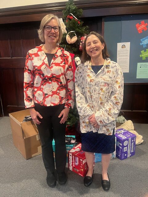 Liz Ramos and Sally Brickell in pajama tops in church parlor