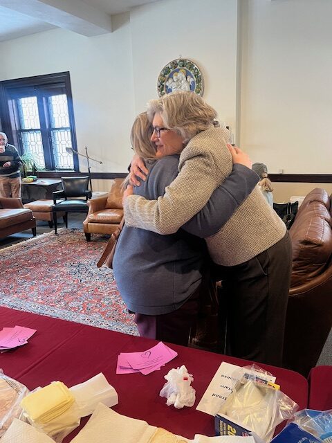 Susan Cartmell getting a farewell hug