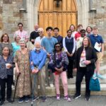 walkers gathered o n church front steps