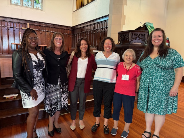 Group of women speakers at front of church sanctuary
