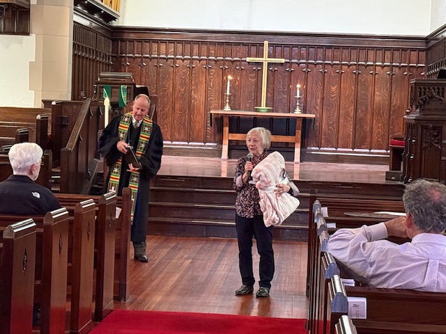Kitty Rieske announcing towel drive in front of sanctuary