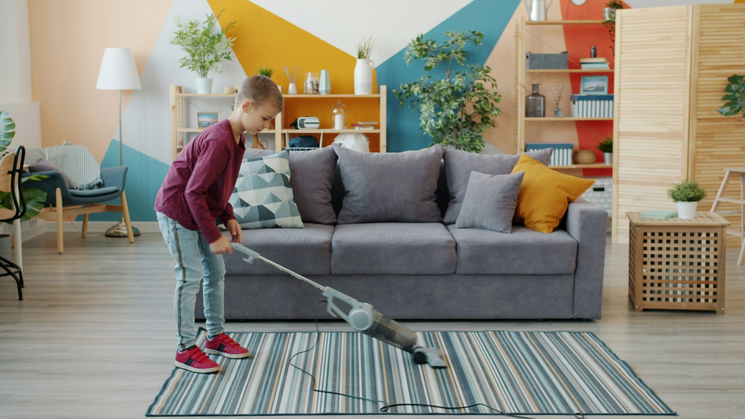 Boy vacuuming rug