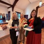 3 women smiing in the church's Great Hall