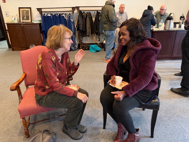 Two women seated in the church parlor talking