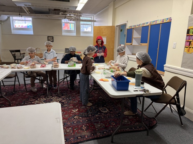 Children making sandwiches in church school room.